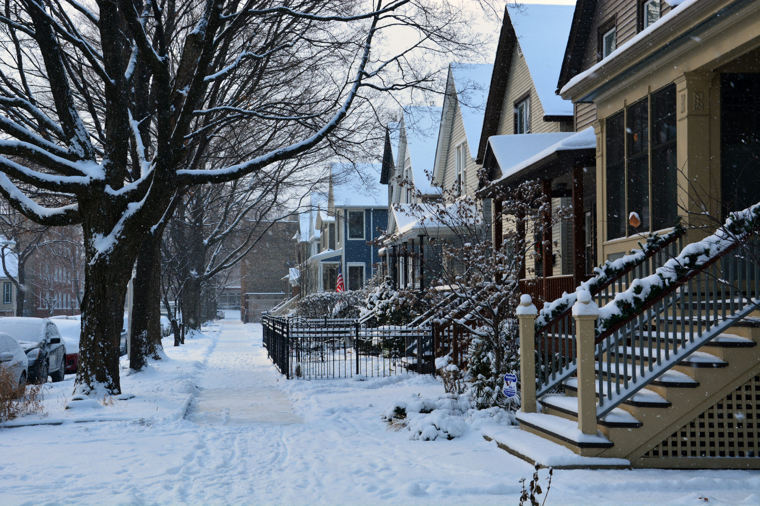 sell home in January - Fresh snow covers the sidewalk in a residential neighborhood of Chicago